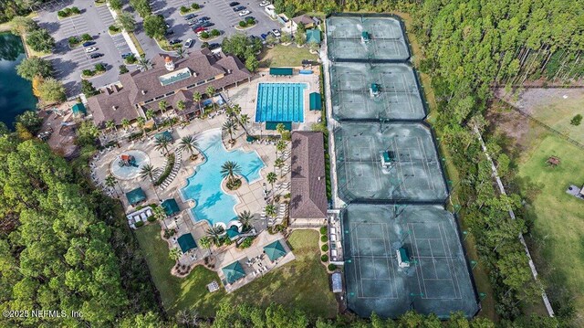 aerial view of property and surrounding area with a pool area
