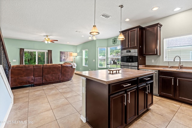 1479 King Rail Ln, Middleburg, FL 32068 - kitchen with a sink, healthy amount of natural light, light tile patterned flooring, dark brown cabinetry, and recessed lighting