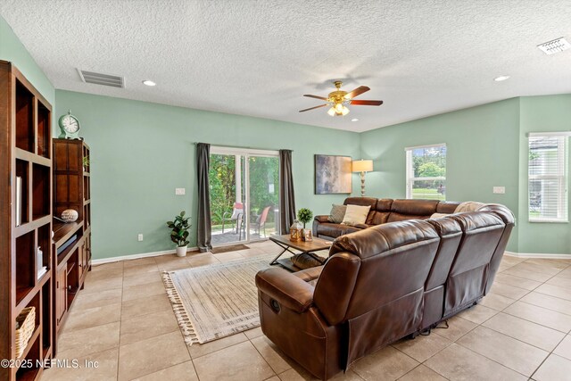 1479 King Rail Ln, Middleburg, FL 32068 - living area with light tile patterned flooring, a ceiling fan, healthy amount of natural light, a textured ceiling, and recessed lighting
