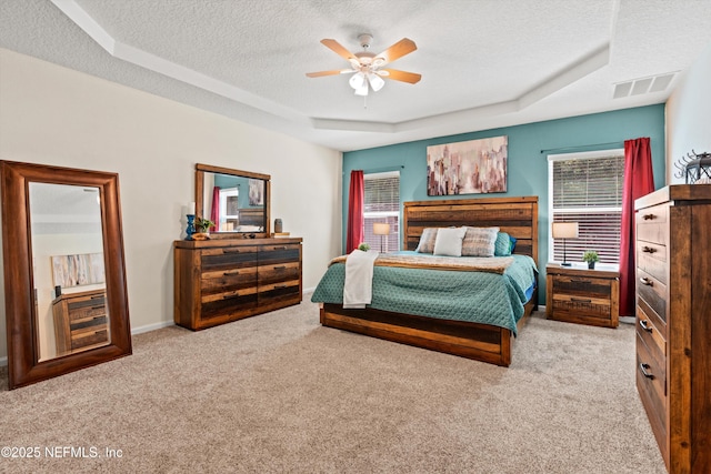 1479 King Rail Ln, Middleburg, FL 32068 - carpeted bedroom featuring a textured ceiling, a raised ceiling, and ceiling fan