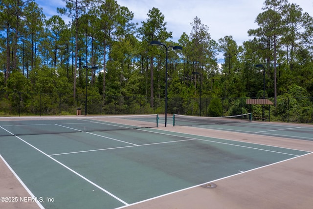 1479 King Rail Ln, Middleburg, FL 32068 - view of tennis court featuring community basketball court, fence, and a forest view