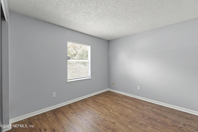 11437 Ricky Way, Jacksonville, FL 32223 - spare room featuring wood finished floors, a textured ceiling, and baseboards