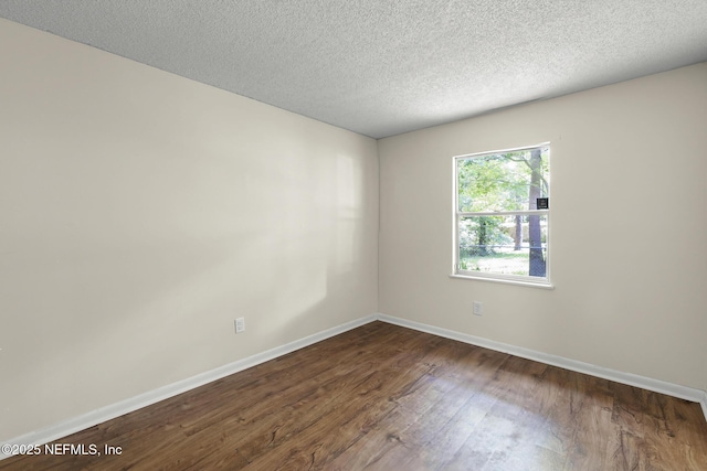 11437 Ricky Way, Jacksonville, FL 32223 - unfurnished room featuring dark wood-style floors, baseboards, and a textured ceiling