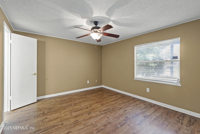 11437 Ricky Way, Jacksonville, FL 32223 - empty room with wood finished floors, a ceiling fan, baseboards, and a textured ceiling
