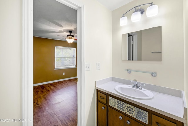 11437 Ricky Way, Jacksonville, FL 32223 - bathroom with wood finished floors, a ceiling fan, vanity, and baseboards