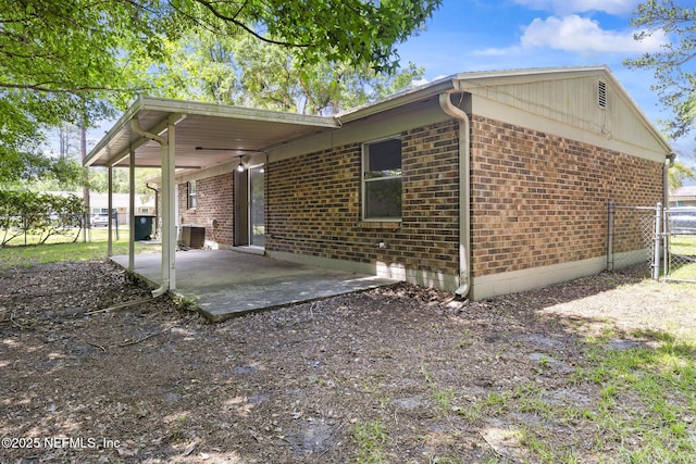 11437 Ricky Way, Jacksonville, FL 32223 - back of property featuring brick siding, a patio, fence, and central air condition unit
