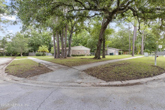 11437 Ricky Way, Jacksonville, FL 32223 - view of front of house featuring a front yard, driveway, and view of wooded area