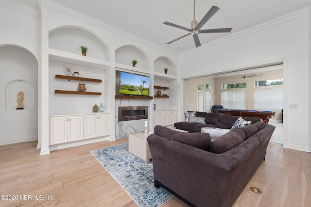 400 Big Tree Rd, Ponte Vedra Beach, FL 32082 - living area with built in shelves, crown molding, light wood finished floors, a ceiling fan, and a high end fireplace