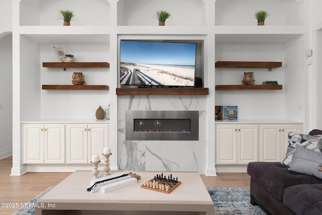 400 Big Tree Rd, Ponte Vedra Beach, FL 32082 - living area featuring light wood finished floors, built in features, and a high end fireplace