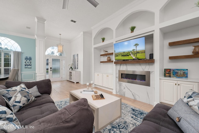 400 Big Tree Rd, Ponte Vedra Beach, FL 32082 - living area with built in features, light wood finished floors, ornamental molding, a fireplace, and a ceiling fan