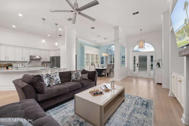400 Big Tree Rd, Ponte Vedra Beach, FL 32082 - living room with ornate columns, light wood finished floors, ceiling fan, recessed lighting, and crown molding