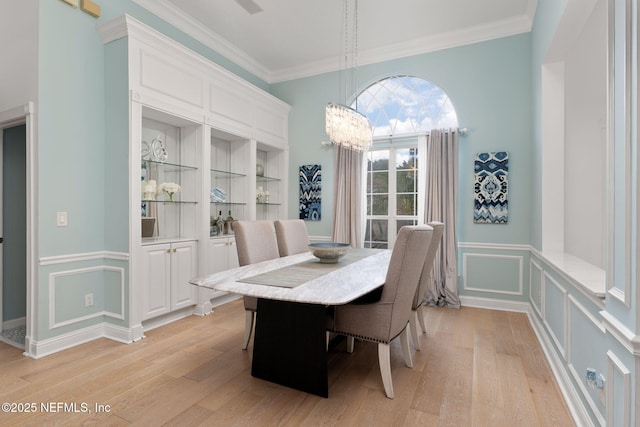 400 Big Tree Rd, Ponte Vedra Beach, FL 32082 - dining area featuring light wood-type flooring, crown molding, a decorative wall, a chandelier, and a wainscoted wall