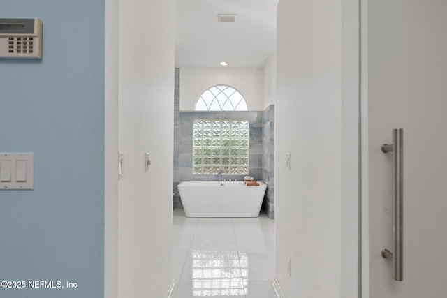 400 Big Tree Rd, Ponte Vedra Beach, FL 32082 - bathroom featuring a freestanding tub, tile patterned floors, tile walls, and recessed lighting