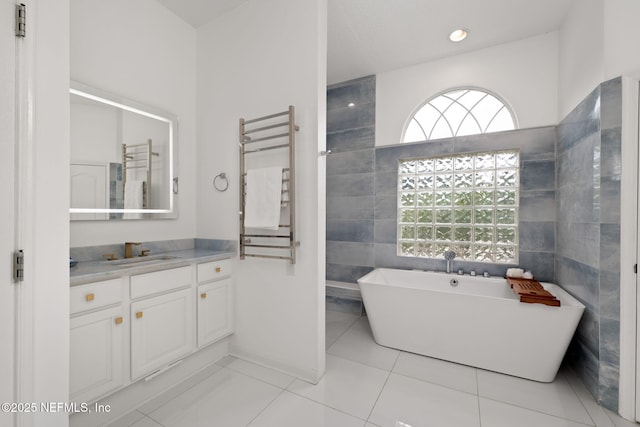 400 Big Tree Rd, Ponte Vedra Beach, FL 32082 - bathroom with a freestanding tub, a towel warmer, vanity, tile patterned floors, and radiator heating unit