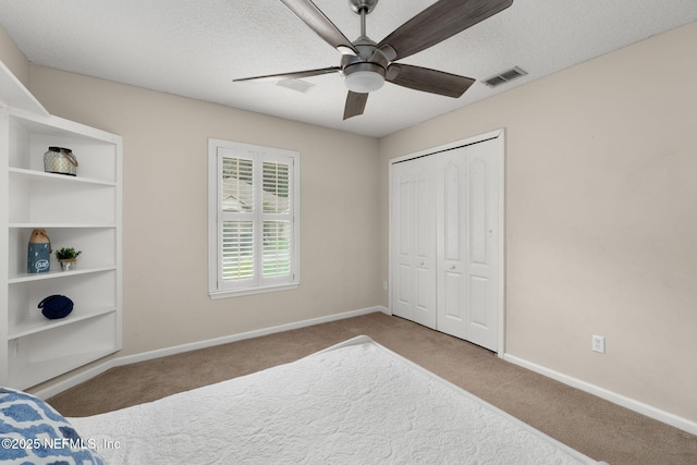 400 Big Tree Rd, Ponte Vedra Beach, FL 32082 - unfurnished bedroom featuring carpet floors, baseboards, a closet, a textured ceiling, and a ceiling fan