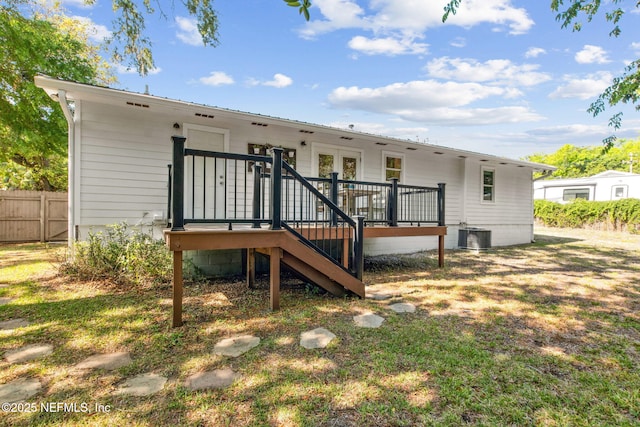 1411 Leon St, Fernandina Beach, FL 32034 - rear view of house with fence, a wooden deck, french doors, and metal roof