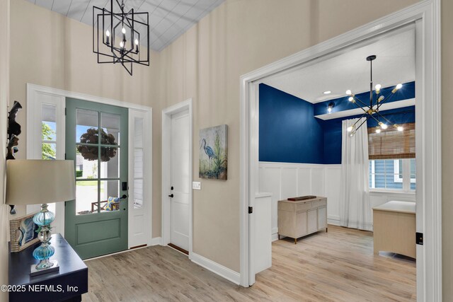 37 High Ridge Pt, Ponte Vedra, FL 32081 - entryway featuring a chandelier, wood finished floors, a towering ceiling, a wainscoted wall, and a decorative wall