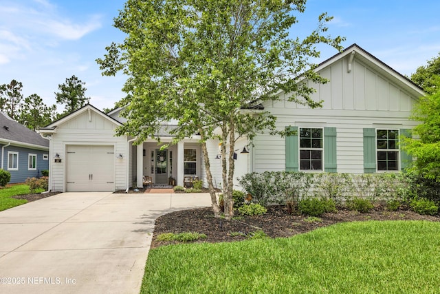 37 High Ridge Pt, Ponte Vedra, FL 32081 - view of front of property featuring board and batten siding, a garage, driveway, and a front yard