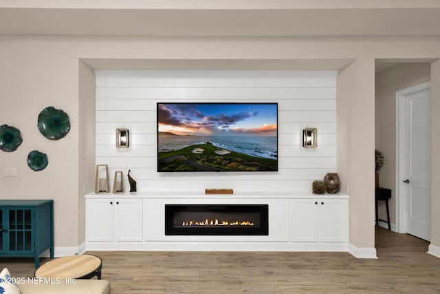 37 High Ridge Pt, Ponte Vedra, FL 32081 - living room with light wood-type flooring, a glass covered fireplace, and baseboards