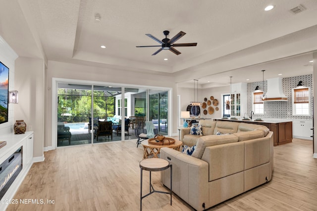 37 High Ridge Pt, Ponte Vedra, FL 32081 - living area featuring a raised ceiling, light wood-style floors, ceiling fan, healthy amount of natural light, and recessed lighting
