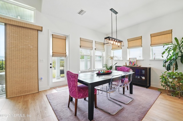dining room featuring light wood finished floors and baseboards