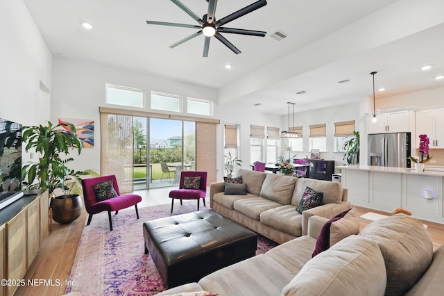 living room with ceiling fan, light wood-type flooring, and recessed lighting