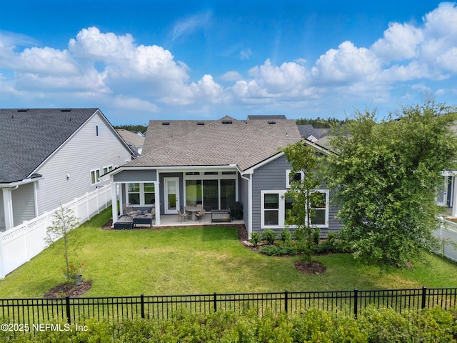 rear view of property featuring a patio and a shingled roof