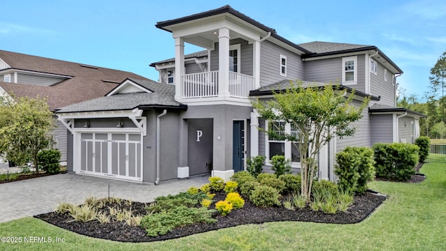 252 Pine Haven Dr, Saint Johns, FL 32259 - view of front facade featuring a balcony, decorative driveway, an attached garage, and a front lawn