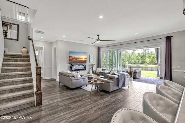 252 Pine Haven Dr, Saint Johns, FL 32259 - living room featuring dark wood-style floors, ceiling fan, stairs, ornamental molding, and baseboards