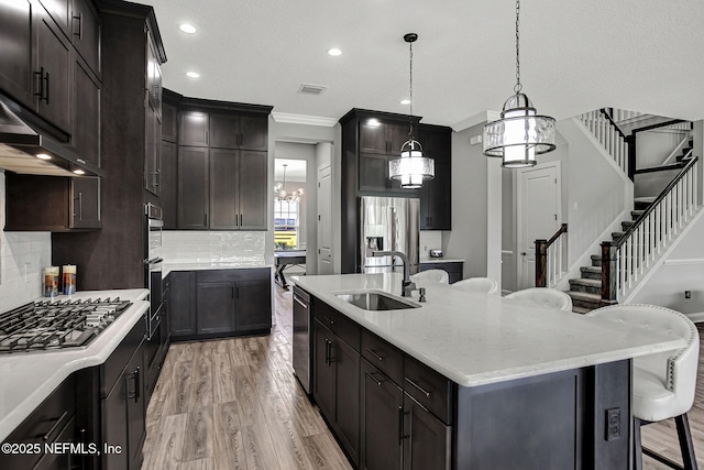 252 Pine Haven Dr, Saint Johns, FL 32259 - kitchen with a sink, appliances with stainless steel finishes, a chandelier, tasteful backsplash, and light wood-style floors