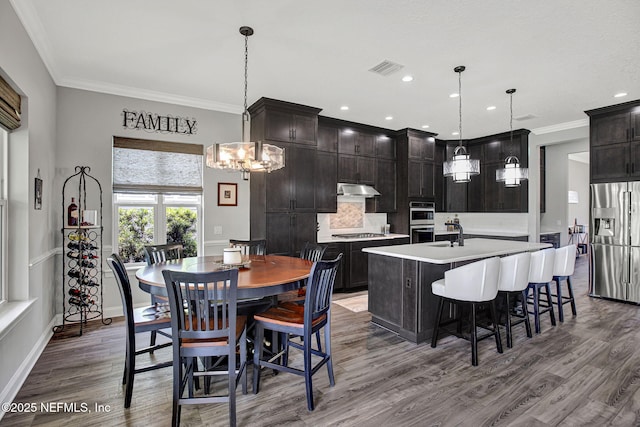 252 Pine Haven Dr, Saint Johns, FL 32259 - dining room featuring wood finished floors, ornamental molding, a chandelier, recessed lighting, and baseboards