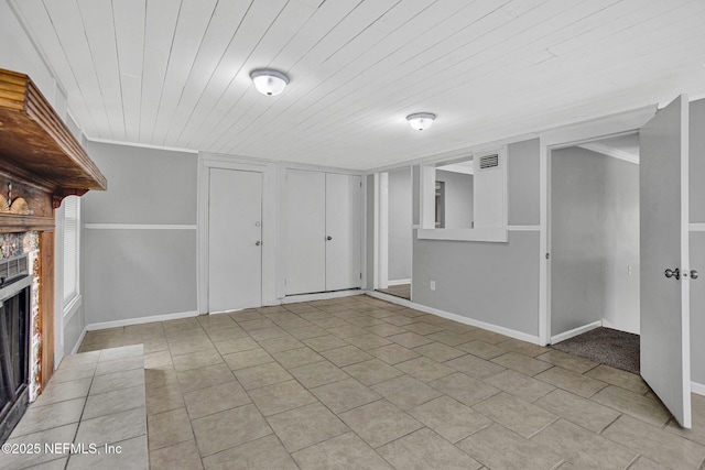 3733 Cambay Pl, Jacksonville, FL 32210 - unfurnished living room with a fireplace, wood ceiling, light tile patterned floors, and baseboards