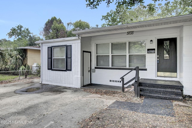 3733 Cambay Pl, Jacksonville, FL 32210 - view of front facade featuring concrete block siding and fence