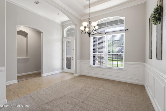 1456 Coopers Hawk Way, Middleburg, FL 32068 - unfurnished dining area featuring a chandelier, arched walkways, crown molding, light tile patterned floors, and wainscoting