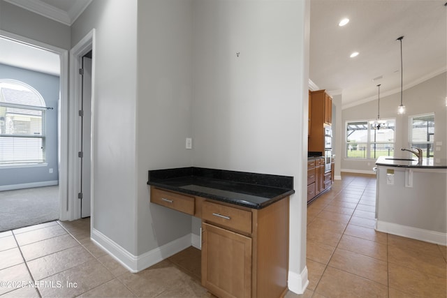 1456 Coopers Hawk Way, Middleburg, FL 32068 - kitchen featuring baseboards, light tile patterned flooring, lofted ceiling, a sink, and crown molding