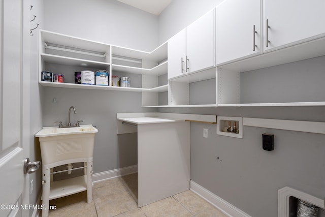 1456 Coopers Hawk Way, Middleburg, FL 32068 - laundry area featuring cabinet space, hookup for a washing machine, light tile patterned flooring, and baseboards
