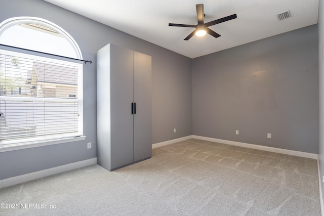 1456 Coopers Hawk Way, Middleburg, FL 32068 - empty room featuring a ceiling fan, plenty of natural light, light carpet, and baseboards