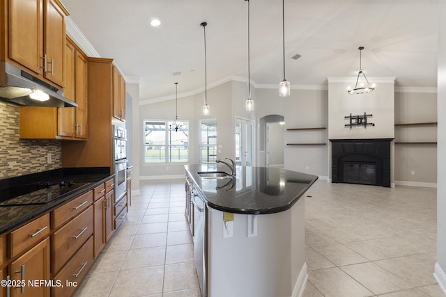 1456 Coopers Hawk Way, Middleburg, FL 32068 - kitchen featuring under cabinet range hood, a sink, a chandelier, tasteful backsplash, and brown cabinets