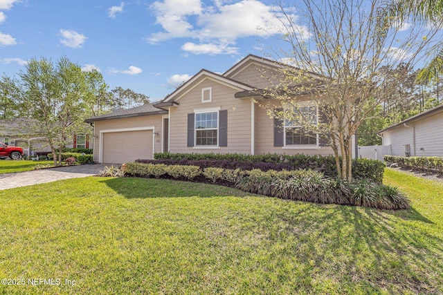ranch-style house featuring a garage, a front yard, and driveway