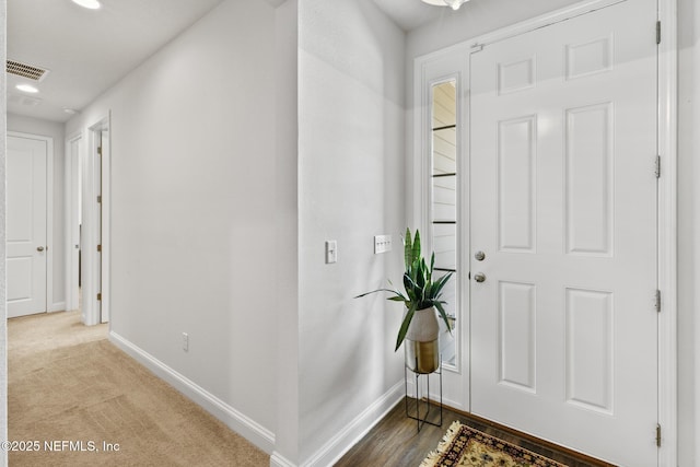 entryway featuring baseboards, recessed lighting, and carpet floors
