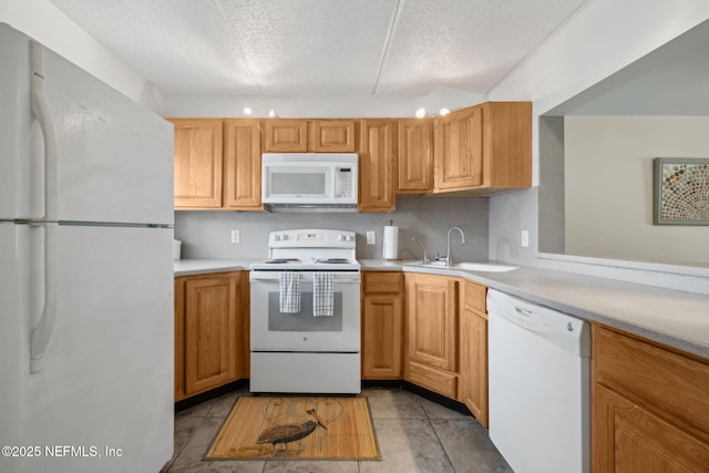 8550 A1A S Unit 340, Saint Augustine, FL 32080 - kitchen with white appliances, a textured ceiling, light countertops, a sink, and light tile patterned flooring
