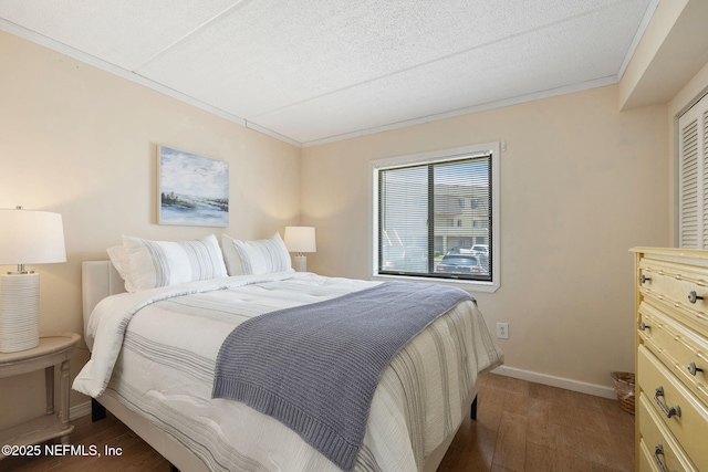 8550 A1A S Unit 340, Saint Augustine, FL 32080 - bedroom featuring wood finished floors, baseboards, a textured ceiling, and crown molding