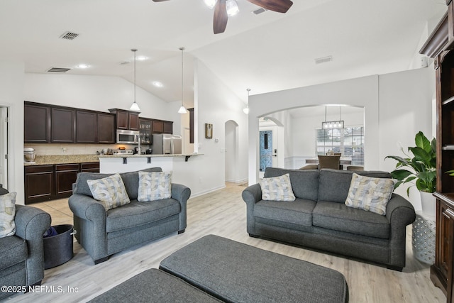 3228 Deer Creek Dr, Middleburg, FL 32068 - living room featuring arched walkways, a ceiling fan, light wood-style floors, and high vaulted ceiling