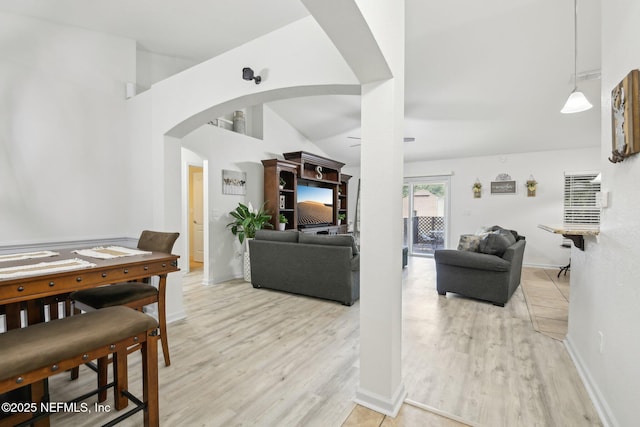 3228 Deer Creek Dr, Middleburg, FL 32068 - living area featuring arched walkways, light wood finished floors, and baseboards