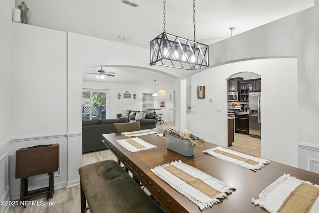 3228 Deer Creek Dr, Middleburg, FL 32068 - dining space with arched walkways, ceiling fan, and light wood-style floors