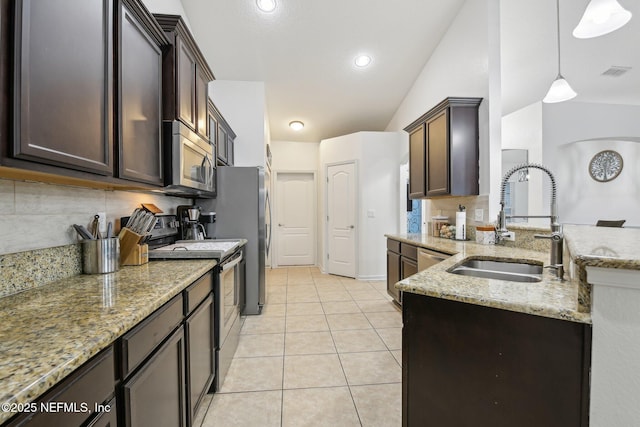 3228 Deer Creek Dr, Middleburg, FL 32068 - kitchen featuring stainless steel appliances, a sink, lofted ceiling, light stone counters, and tasteful backsplash