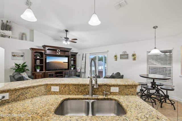 3228 Deer Creek Dr, Middleburg, FL 32068 - kitchen featuring a sink, a ceiling fan, vaulted ceiling, light stone counters, and pendant lighting