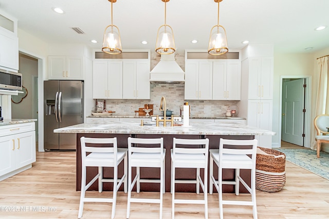 4282 Wolfe Dr, Macclenny, FL 32063 - kitchen featuring stainless steel appliances, decorative backsplash, light wood-style floors, a breakfast bar area, and recessed lighting