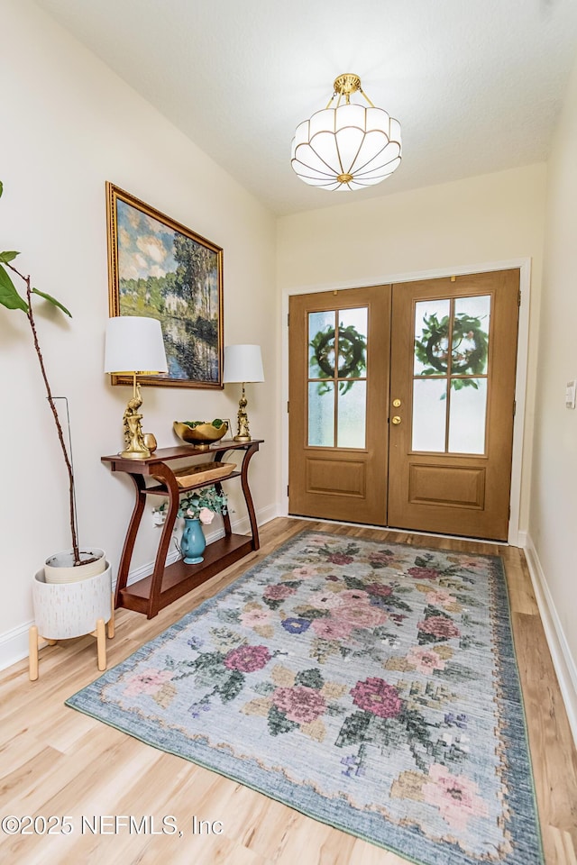 4282 Wolfe Dr, Macclenny, FL 32063 - foyer featuring french doors, wood finished floors, and baseboards