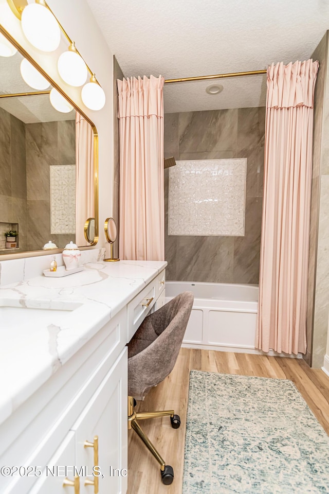 4282 Wolfe Dr, Macclenny, FL 32063 - bathroom featuring vanity, shower / tub combo with curtain, wood finished floors, and a textured ceiling